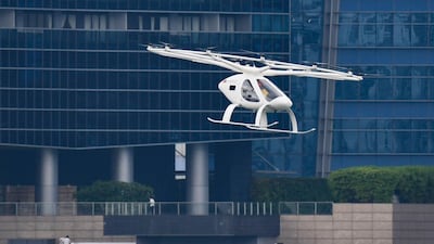 A Volocopter unmanned air taxi transport flies over Marina Bay during test flight with a safety pilot at the 26th Intelligent Transport Systems World Congress (ITSWC) in Singapore. AFP