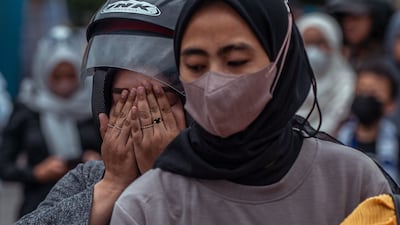 People pay their respects to the victims. AFP