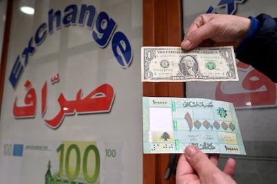 A Lebanese citizen with a $1 note and 100,000 Lebanese pounds outside a currency exchange in Beirut. EPA