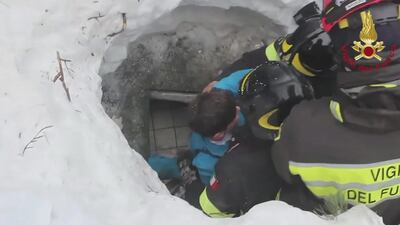 Italian firemen rescue two children on January 20, 2017 at the Hotel Rigopiano in central Italy, which was hit by a massive avalanche believed to have been triggered by an earthquake earlier in the week. EPA