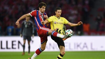 Bayern Munich midfielder Javi Martinez, left, and Borussia Dortmund striker Robert Lewandowski vie for the ball during the German Cup final. Patrik Stollarz / AFP / May 17, 2014