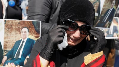 A supporter of former Egyptian President Hosni Mubarak reacts at a gathering near the main gate of a cemetery during his burial ceremony, east of Cairo, Egypt February 26, 2020. REUTERS/Mohamed Abd El Ghany TPX IMAGES OF THE DAY