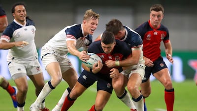 England's Ben Youngs is challenged at the Kobe Misaki Stadium. PA