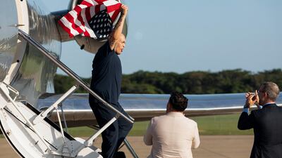 One of the 10 US citizens in an exchange between Washington and the Venezuelan government waves an American flag on arrival in San Luis Talpa, El Salvador. AFP