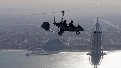 A two-man gyrocopter flies along the coast off Dubai near to the Burj Al Arab hotel during last year’s World Air Games. Karim Sahib / Reuters