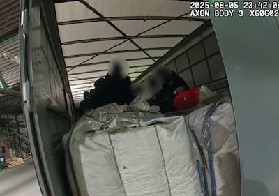 The moment NCA officers opened the back of a lorry to find migrants inside. Photo: NCA