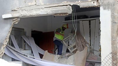 A member of the Lebanese civil defence inspects a house shelled by Israeli forces on the outskirts of the border village of Dhaira on Wednesday. AFP