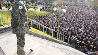 G-Dragon (L), a member of South Korean boy band BIGBANG, looks at fans who came to greet his discharge from mandatory military service at a military base in Yongin, South Korea, 26 October 2019. EPA