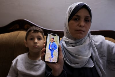Hind Rajab’s grandmother shows a photo of her granddaughter, who was named after her. Ahmed, her grandson, is sitting beside her. Reuters
