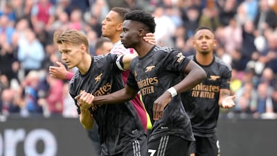 Arsenal's Martin Odegaard, left, puts his arm around Bukayo Saka after Saka's missed penalty. AP Photo