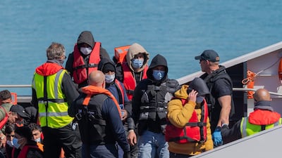 The UK Border Force brings people ashore at Dover Harbour who were attempting to get to Britain in four boats. EPA