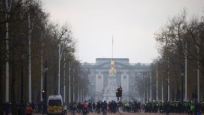 People walk in front of Buckingham Palace as they participate in an anti-lockdown demonstration amid the coronavirus disease (COVID-19) outbreak in London. Reuters