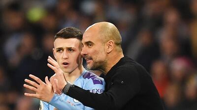 Phil Foden of Manchester City speaks with Pep Guardiola. Getty