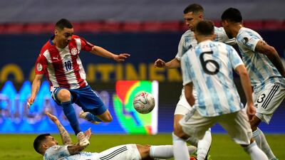 Paraguay's Miguel Almiron, left above, jumps over Argentina's Leandro Paredes. AP