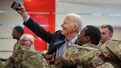 Mr Biden takes a selfie with US soldiers near Rzeszow. Reuters