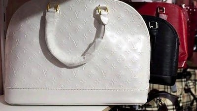 Counterfeit designer handbags sit on shelves of a secret room of a store at Karama Market in Dubai. Andrew Henderson / The National