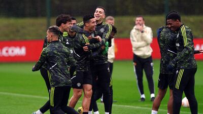 Cristiano Ronaldo and Diogo Dalot share a laugh at the AON Training Complex. PA