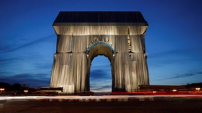 The wrapped Arc de Triomphe at dusk. AFP