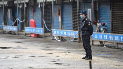 A security guard stands outside the Huanan Seafood Wholesale Market where the coronavirus was detected in Wuhan on January 24, 2020. AFP