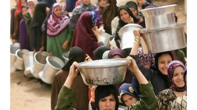 Egyptian women wait in a queue to fill their containers with clean water at Al Rahawe village, north-east of Cairo. AFP