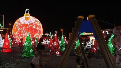 Ivory Coast: Children play on swings in a playground surrounded by Christmas decorations in Abidjan. AFP Photo/ Sia Kambou