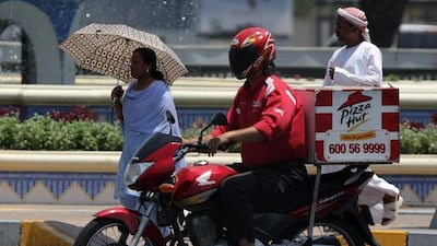 A worker for fast-food franchise Pizza Hut makes a delivery. A survey shows a sizeable number of professionals relying on junk food.