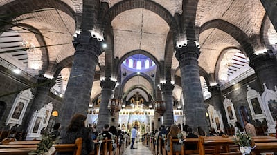 Syrian Catholics attend a Palm Sunday service at the Cathedral of Our Lady of Dormition in Damascus. AFP