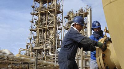 Workers perform maintenance on oil pipelines at the Sirte Oil Company in Brega. Esam Omran Al Fetori / Reuters