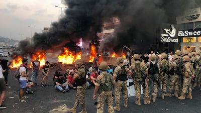 Demonstrators sit together during a protest over deteriorating economic situation, in the city of Jounieh, north of Beirut. Reuters