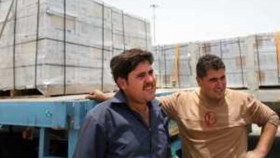 Lorry drivers Ibrahim Haider,left, and Naher Mohammed wait at the Saudi-UAE border in Al Ghuwaifat yesterday.