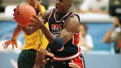 USA's Michael Jordan takes the ball to the hoop past the outstretched arms of Brazil's Josuel Aristides Santos for two points during first half action of their game at the 1992 Olympic Games in Barcelona. AP