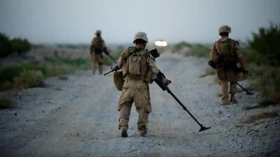 US marines use metal detectors to find improvised explosive devices (IEDs) in Afghanistan's Helmand province. Manpreet Romana / AFP