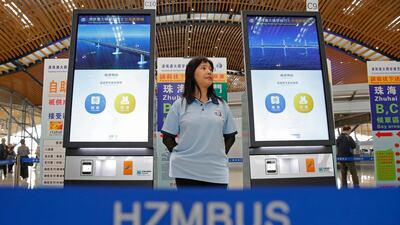 A staff member stands next to the ticket machines in Hong Kong. AP Photo