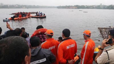 People wait for others to be rescued. EPA