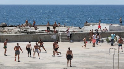 Beirut residents gather at a closed swimming club along the seaside corniche. AFP