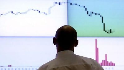 A man looks at an electronic board at RTS stock exchange in Moscow yesterday as global markets swang wildly.