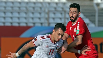 UAE forward Caio Canedo holds off Lebanon's Rabih Ataya. AFP