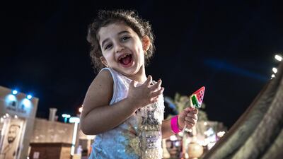 Karolina Ahmed, 3, enjoys her watermelon lolipop and horse ride at the fest.