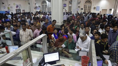 People crowd inside a bank to deposit and exchange discontinued currency notes in Allahabad, India, on November 12, 2016. Rajesh Kumar Singh / AP Photo