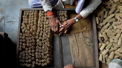 Labourers gather and arrange bidis into bundles for packaging at The New Sarkar Bidi Factory in Kannauj.