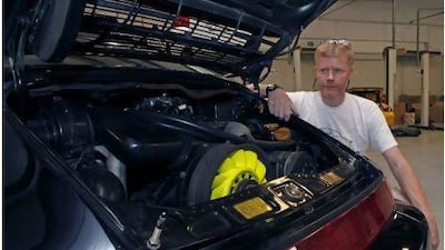 Graham Henderson with his reinvigorated Porsche 911, at House of Cars Garage. Jeffrey E Biteng / The National