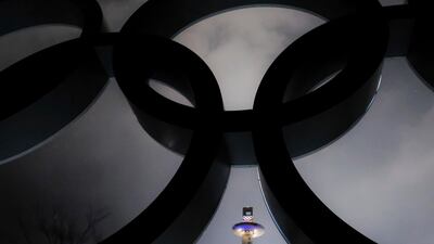The ski jumping tower is framed in the Olympic Rings on a storming night at the 2018 Winter Olympics in Pyeongchang, South Korea. J David Ake / AP Photo