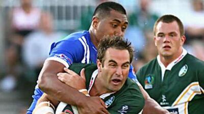 Ryan Tandy of Ireland is tackled during the 2008 Rugby League World Cup Pool 3 match between Ireland and Samoa.