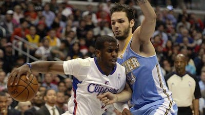 Los Angeles Clippers guard Chris Paul, left, in action against Denver Nuggets guard Evan Fournier in the first half of their NBA game at the Staples Center in Los Angeles, California, USA, 15 April 2014. EPA/MICHAEL NELSON