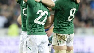 Ireland's fly half Ian Madigan, second left, No 8 Jamie Heaslip, right, celebrate with teammates after winning the Six Nations title by beating France 22-20. Ireland came into the finale tied with England at the top of the table but ahead on points difference. Franck Fife / AFP