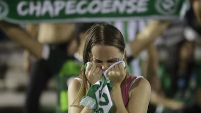 fan of the Brazilian football team Chapecoense weeps during a gathering inside Arena Conda stadium in Chapeco, Brazil, on Tuesday, November 29, 2016 to mourn the footballers killed in an air crash near Medellin, Colombia. Andre Penner / AP Photo
