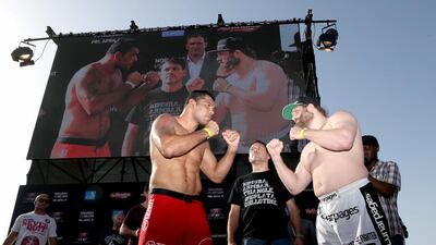 Antonio Nogueira, centre, and Roy Nelson, right, face off after the weigh-in for UFC Fight Night 39 on April 10, 2014, in Abu Dhabi. Maxx Wolfson / Getty Images