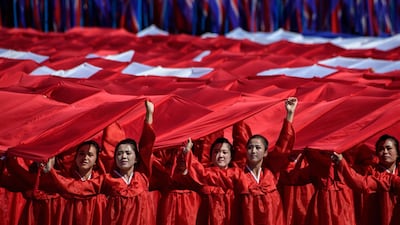 Participants march past a balcony from where North Korea's leader Kim Jong Un was watching, during a mass rally on Kim Il Sung square in Pyongyang. AFP
