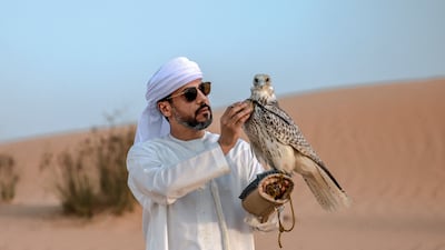 Falconer Ammar bin Humaid Al Marri with one of his birds. Victor Besa / The National
