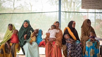 Mothers wait at an MSF health post in Dagahaley to get a nutrition check-up for their children.
